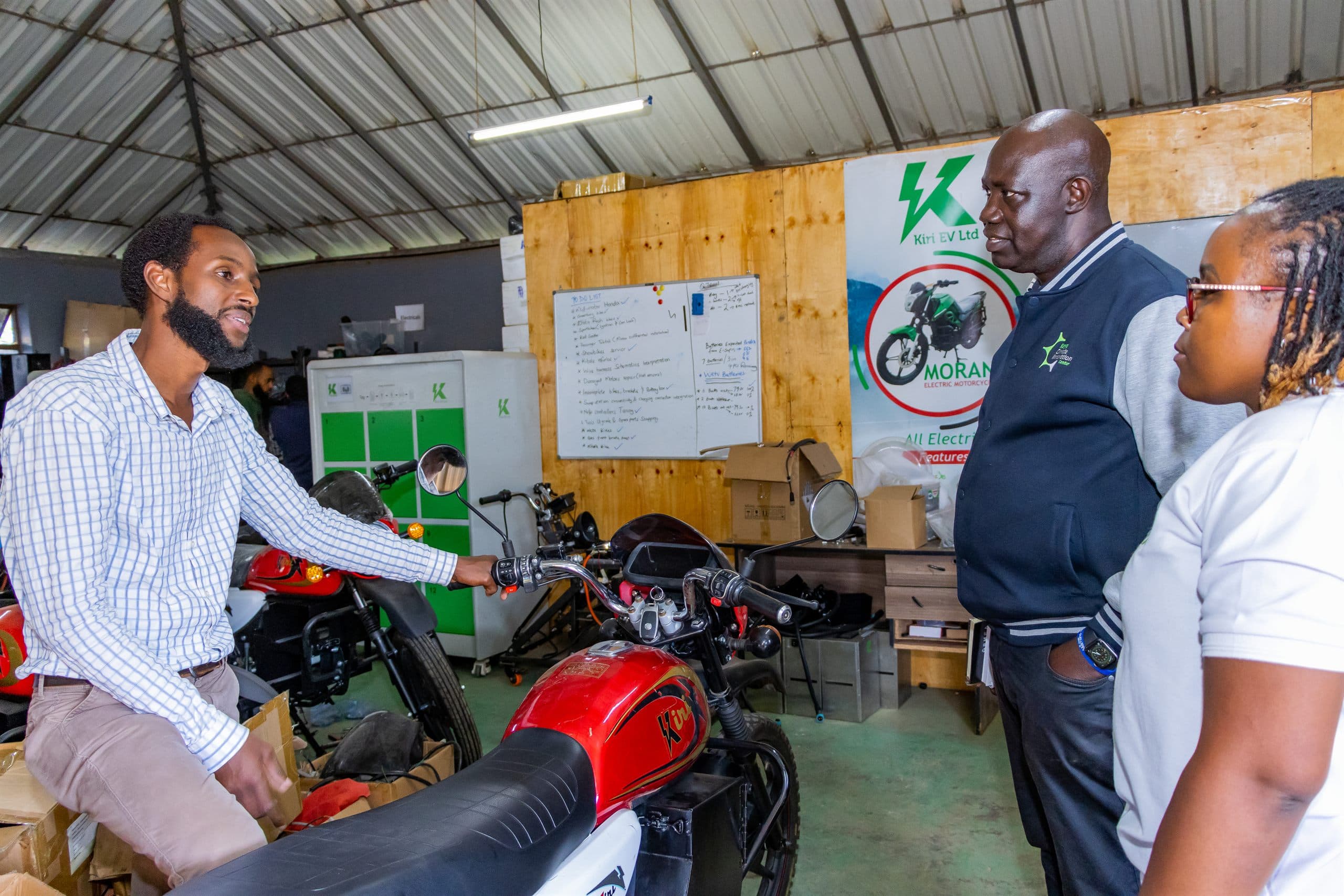 An entrepreneur presenting an electric motorcycle in a workshop